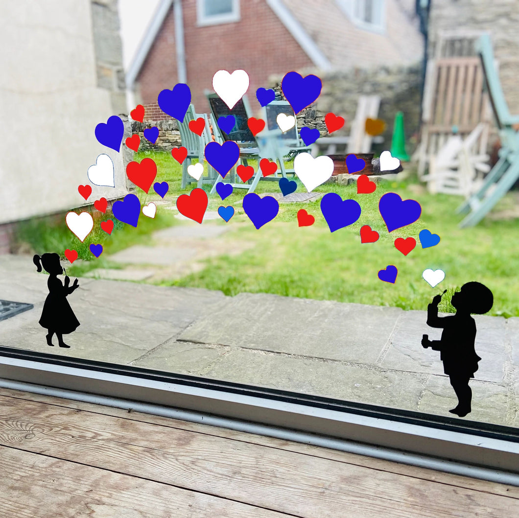 Girl and Boy Blowing Red, White and Blue Heart Stickers - Platinum Jubilee Window Stickers
