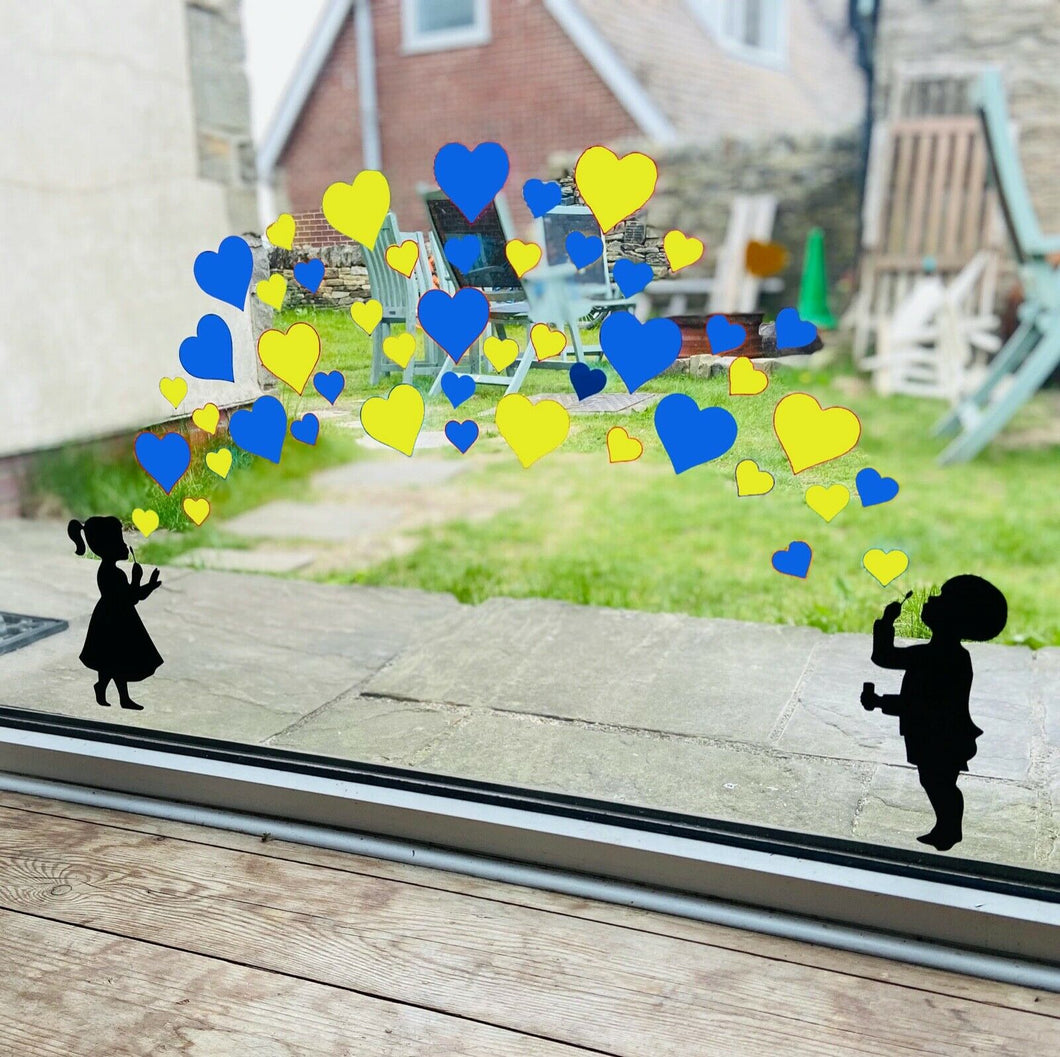 Girl and Boy Blowing Blue and Yellow Heart Stickers - Create Window Wall Glass Display Colours